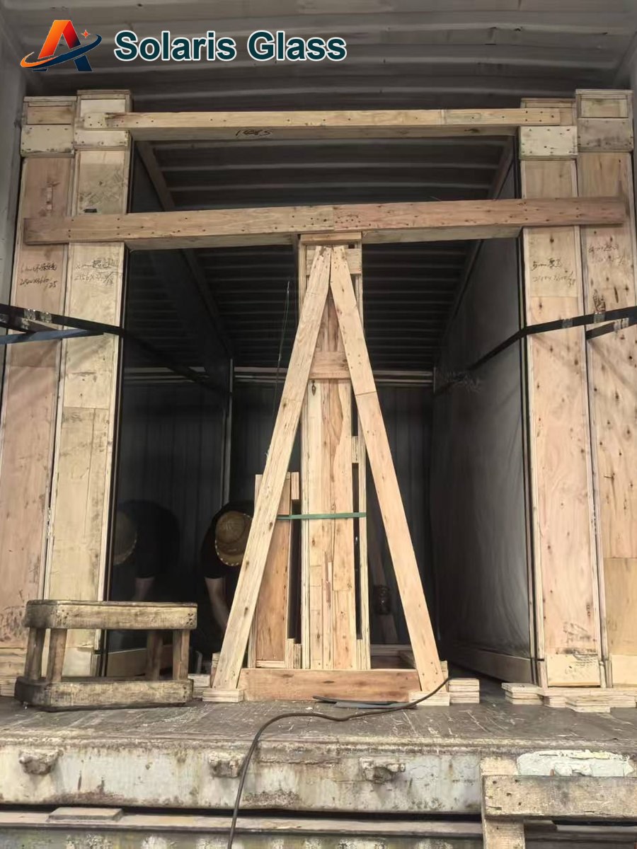 Glass crates being staged and secured inside a loading container