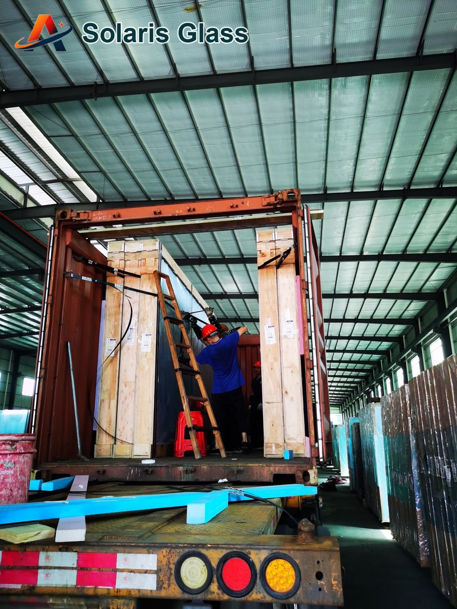 Glass crates being loaded into an export container